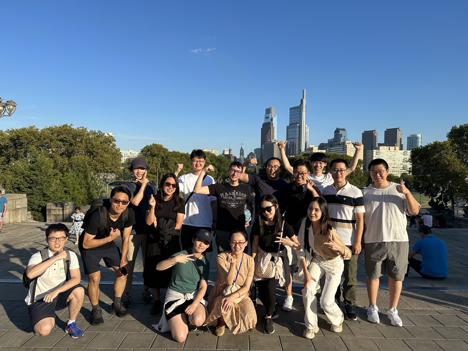 An ISMP group posing on a walk with the Philadelphia skyline behind them